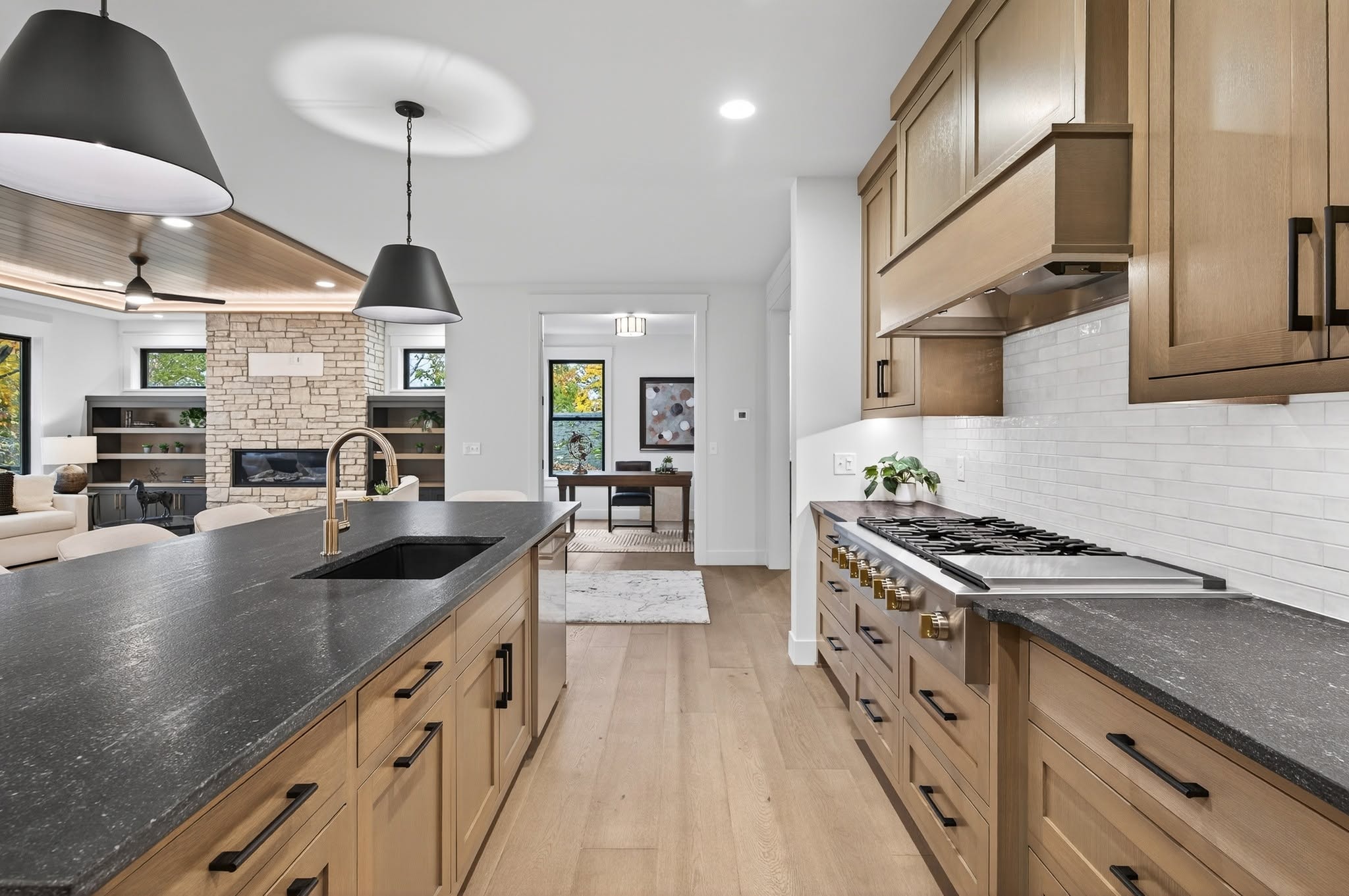 Kitchen with black countertops open to living room